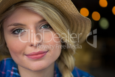 Portrait of woman wearing hat in coffee shop