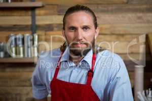 Confident male barista in carefetia