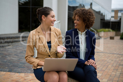 Portrait of two businesswomen interacting with each other