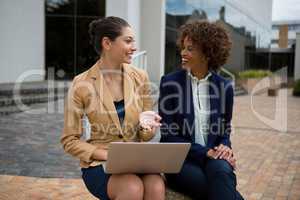 Portrait of two businesswomen interacting with each other