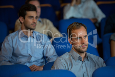 Business executives listening to speech