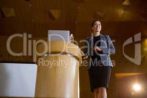 Female business executive giving a speech