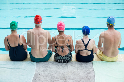 Senior swimmers sitting at poolside