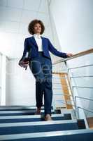 Businesswoman with diary climbing down the stairs