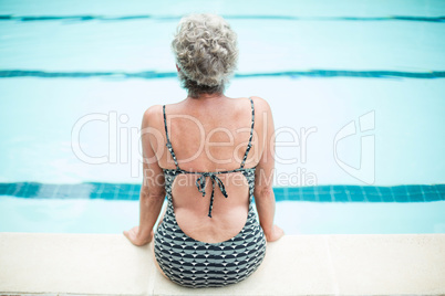 Senior woman sitting on poolside