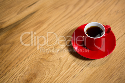 Red cup and saucer on table in cafeteria