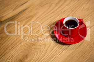 Red cup and saucer on table in cafeteria