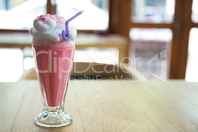 Glass of strawberry shake with cream