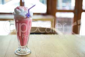 Glass of strawberry shake with cream