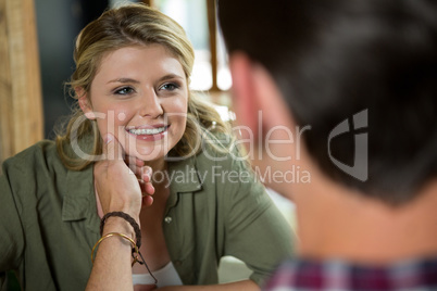 Romantic man touching womans face in coffee shop