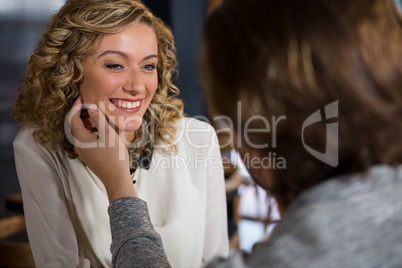 Man touching womans face in coffee shop