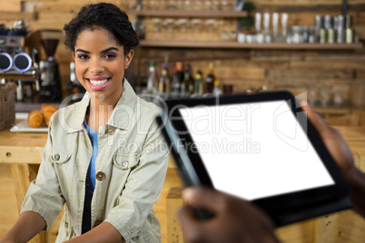 Portrait of smiling female customer in coffee shop