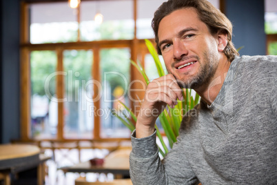 Confident young man in coffee shop