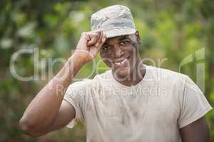 Portrait of happy military soldier holding his cap