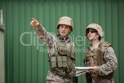 Soldiers showing direction to his colleague