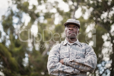 Thoughtful military soldier standing with arms crossed