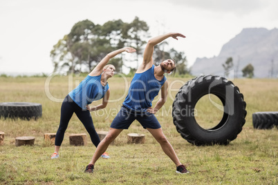 Fit people performing stretching exercise