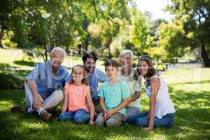 Multi generation family sitting in park
