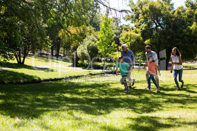 Multi generation family running in the park