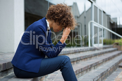 Depressed businesswoman sitting in the premises