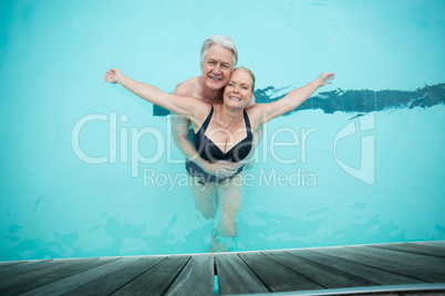 Mature couple swimming in pool