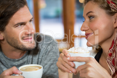 Close-up of romantic couple having coffee in cafeteria