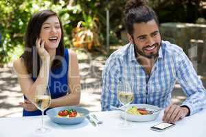 Cheerful couple having lunch at outdoor restaurant