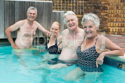 Swimmers leaning on poolside