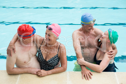 Happy senior couples enjoying in pool