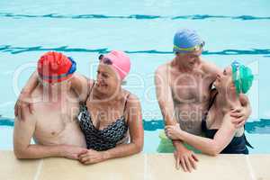 Happy senior couples enjoying in pool