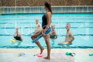 Female trainer demonstrating use of pool noodle