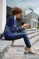 Businesswoman using mobile phone in the premises