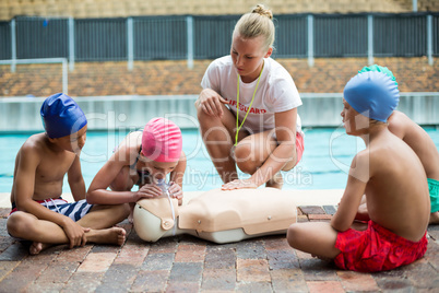 Lifeguard helping children during rescue training