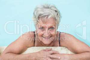 Senior woman leaning on poolside