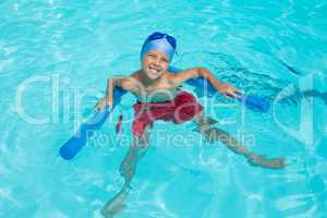 High angle view of cheerful boy swimming in pool