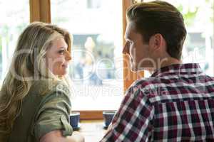 Loving couple looking at each other in coffee house