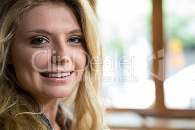 Beautiful young woman smiling in coffee shop