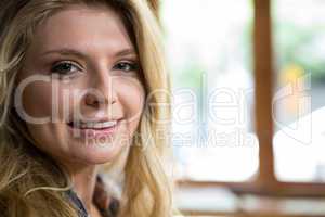 Beautiful young woman smiling in coffee shop