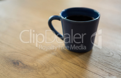 Coffee cup on wooden table in cafe