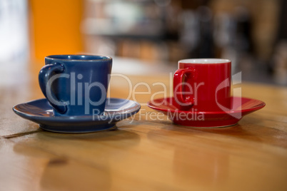 Coffee cups on wooden table in cafeteria