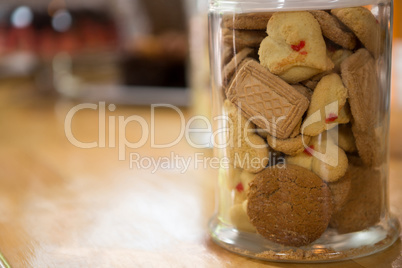 Cookies in jar on counter at coffee shop