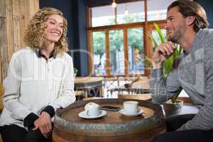 Smiling couple talking in coffee shop