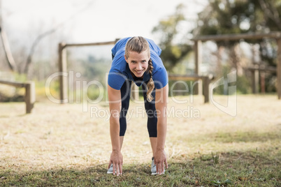 Fit woman exercising in boot camp on a sunny day