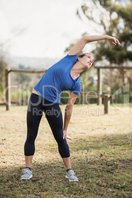 Fit woman exercising in boot camp
