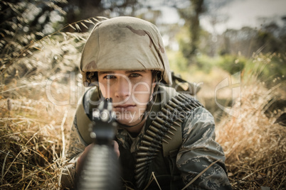 Portrait of military soldier aiming with a rifle