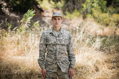 Portrait of military soldier standing in grass