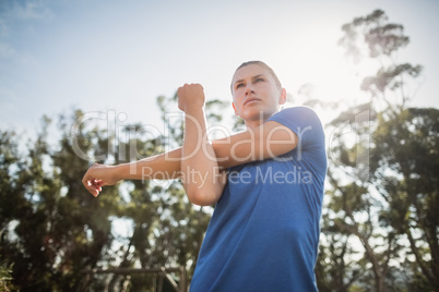Fit woman performing stretching exercise Fit woman performing stretching exercise