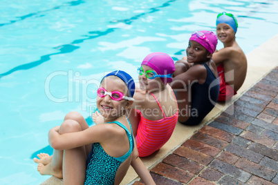 Portrait of little swimmers at poolside