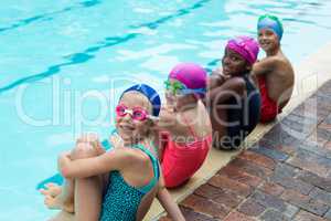 Portrait of little swimmers at poolside