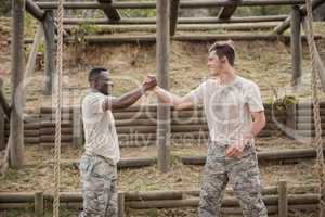 Military man greetings during obstacle course